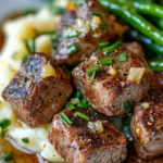 Are you ready to indulge in an easy yet sumptuous meal that's sure to impress your family and friends? These Sizzling Garlic Butter Steak Bites with Comforting Mash & Crisp Green Beans are a true treat for the senses. Imagine juicy steak bites coated in a rich garlic butter sauce, paired with creamy mashed potatoes and vibrant green beans. This meal is perfect for a cozy dinner or a weekend gathering. It combines classic comfort with a gourmet twist, bringing restaurant-quality flavor to your own kitchen!