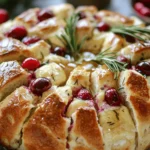 Imagine a warm, golden loaf of Cranberry Brie Sourdough Pull-Apart Bread sitting at the center of your dinner table. Each tear reveals a melty piece of Brie cheese, burst of tart cranberries, and a hint of herbal goodness – it’s a feast for the senses! This recipe is perfect for gatherings, festive occasions, or even just a cozy night in. It combines the rustic charm of sourdough with the creamy richness of Brie and the sweet-tart flavor of cranberries, making it an unforgettable appetizer or snack.